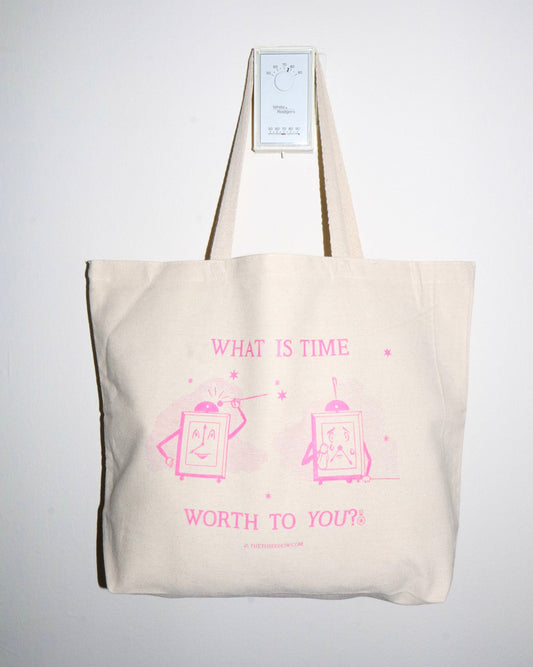 Beige tote bag with pink text and graphics on a white background