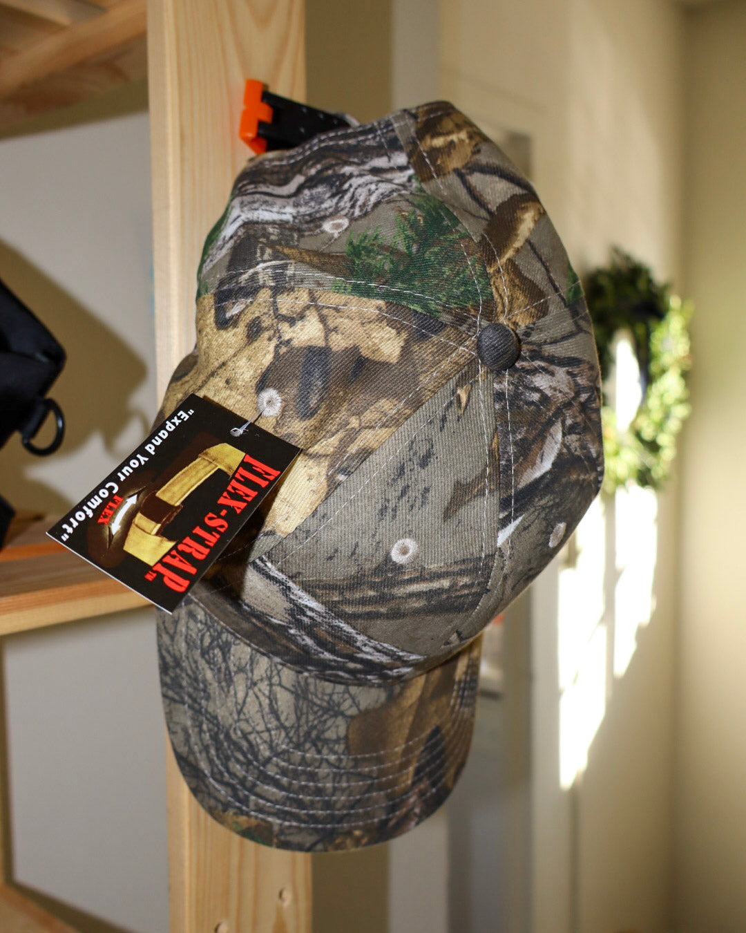 Camouflage cap with a brand tag on a wooden surface