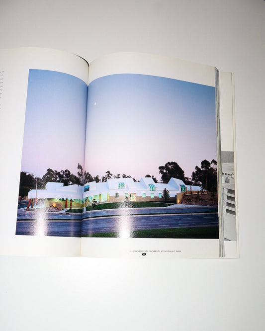 Open book showing a photograph of a building with a blue sky.