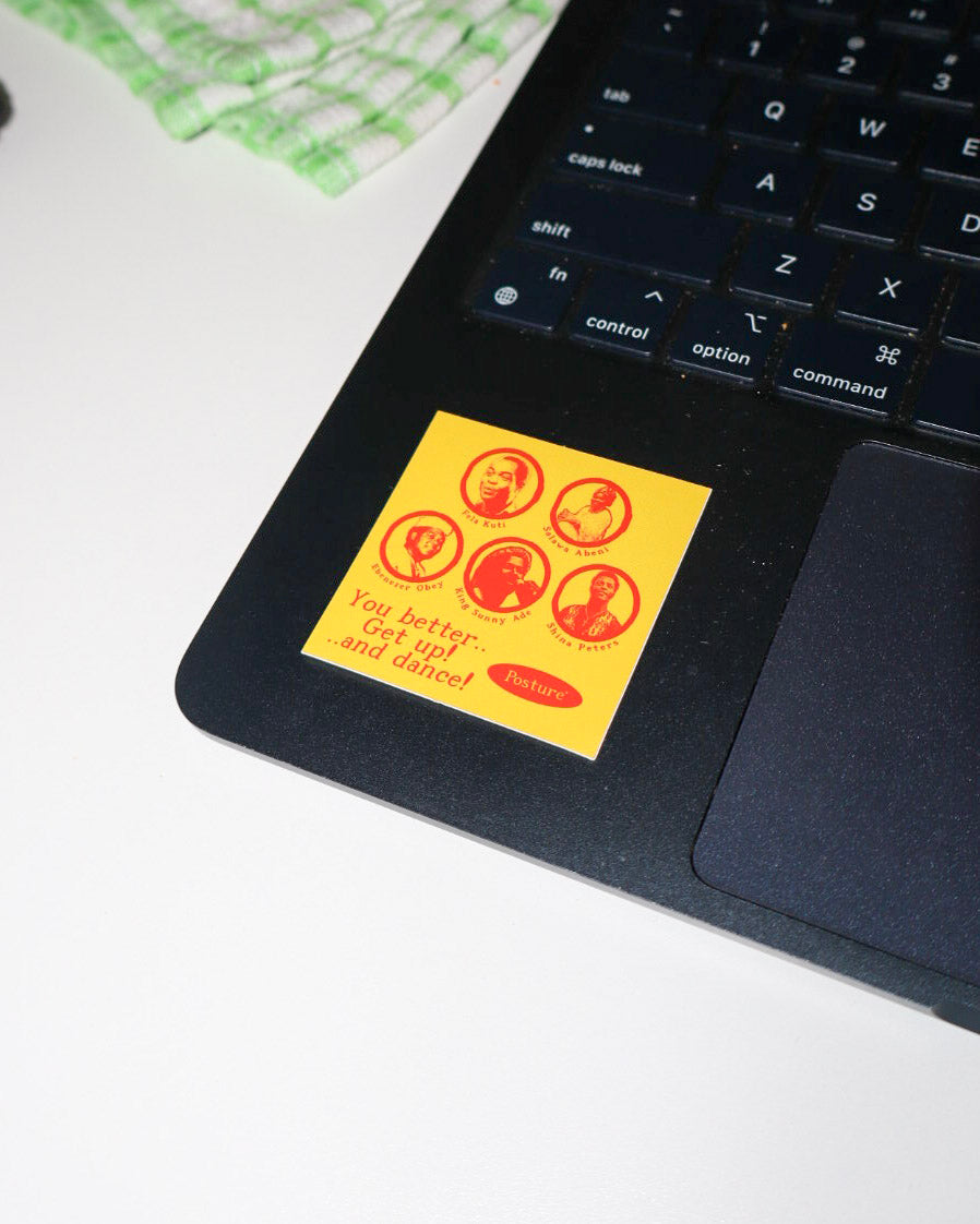 A square yellow sticker with red circular portraits and the text 'You better get up and dance!' applied to the palm rest of a black laptop.