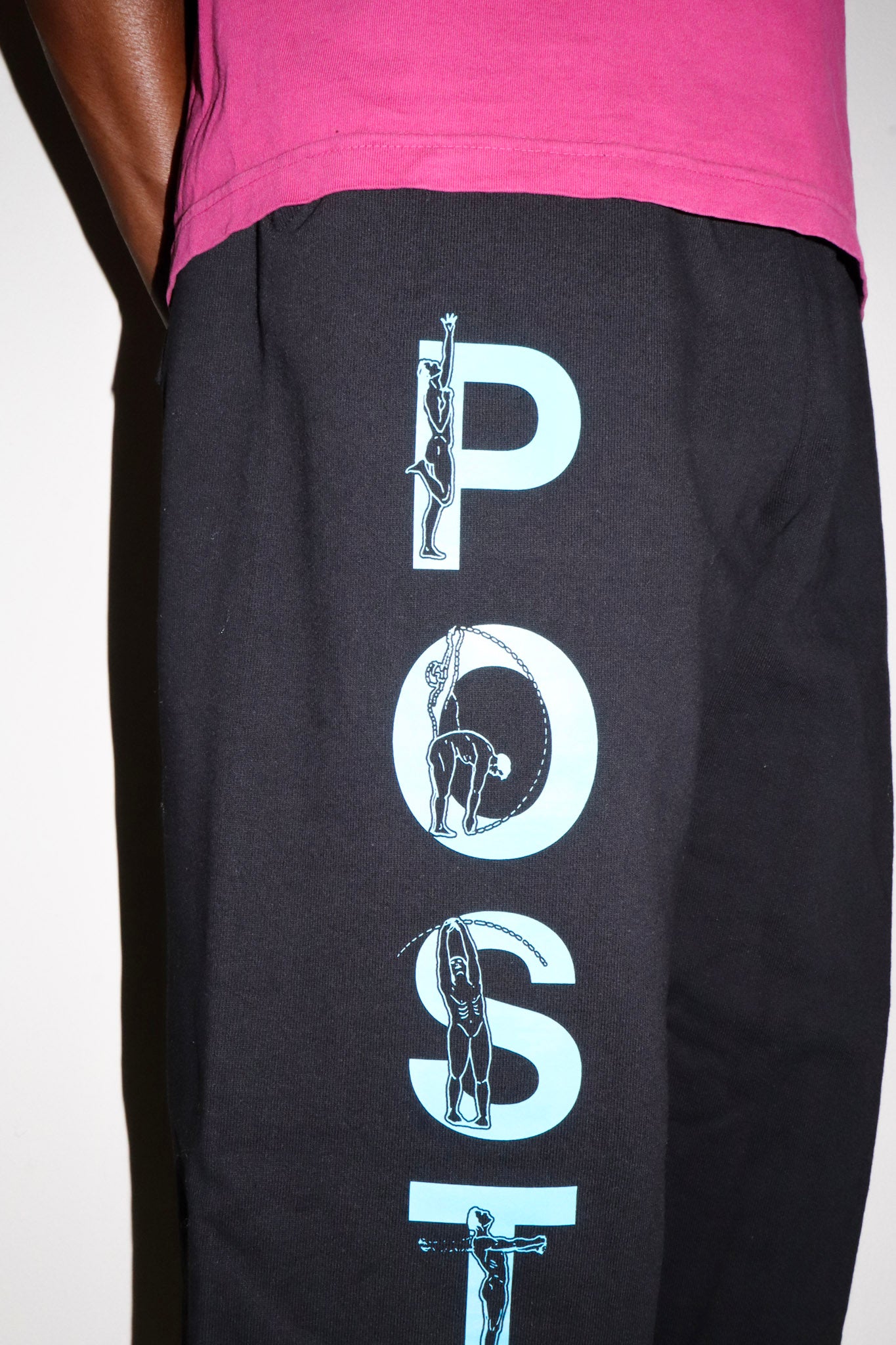 Black pants with white graphic design on a plain background