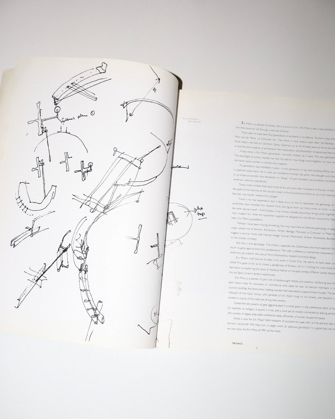 Open book with technical drawings on a white background
