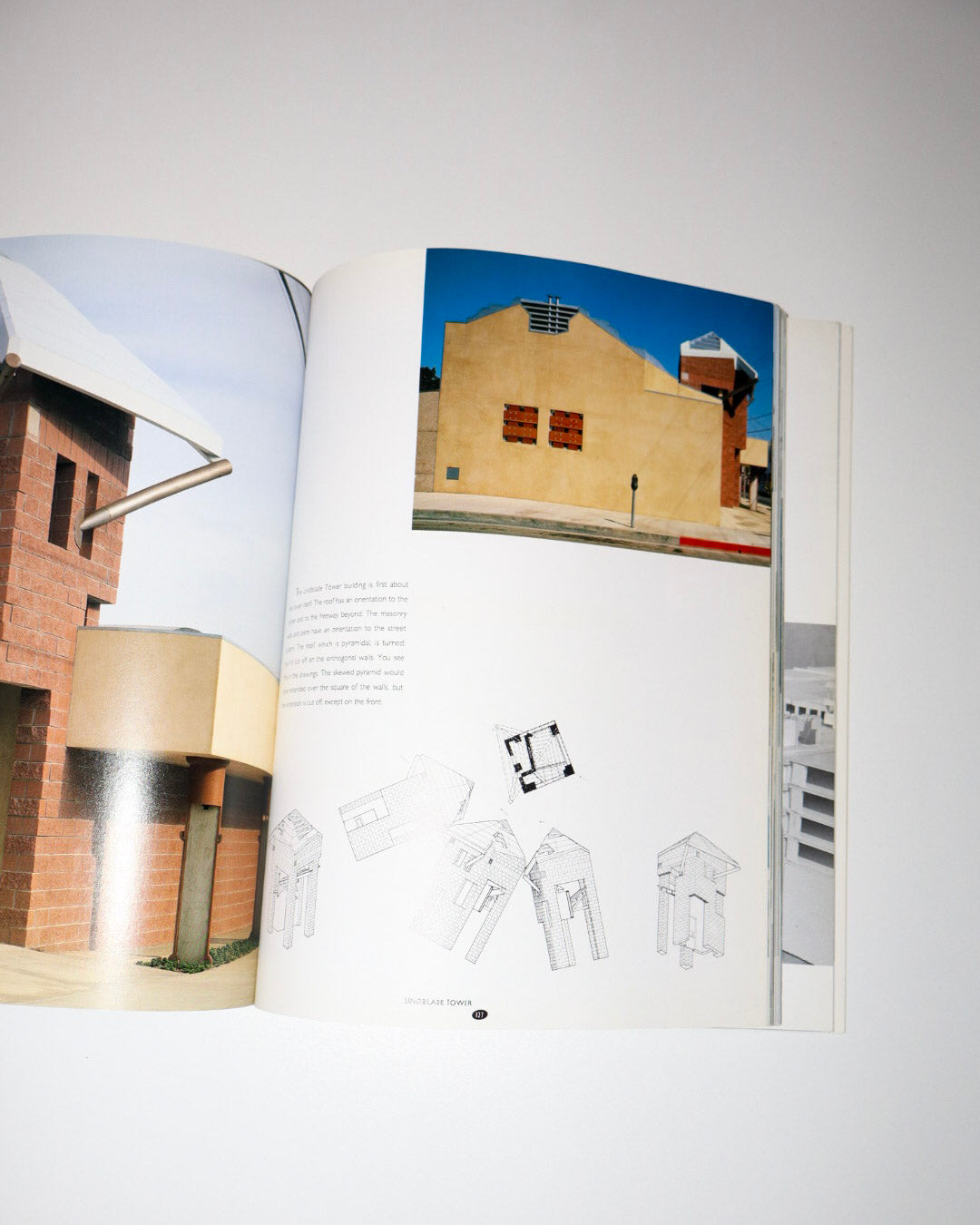 Open book showing architectural drawings and images of buildings.