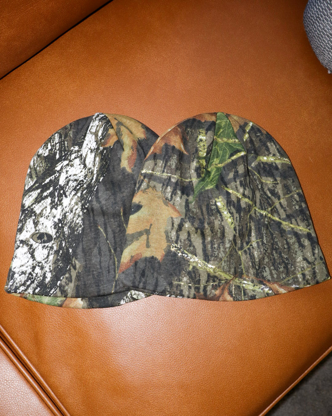 Camouflage-patterned booties on a brown surface