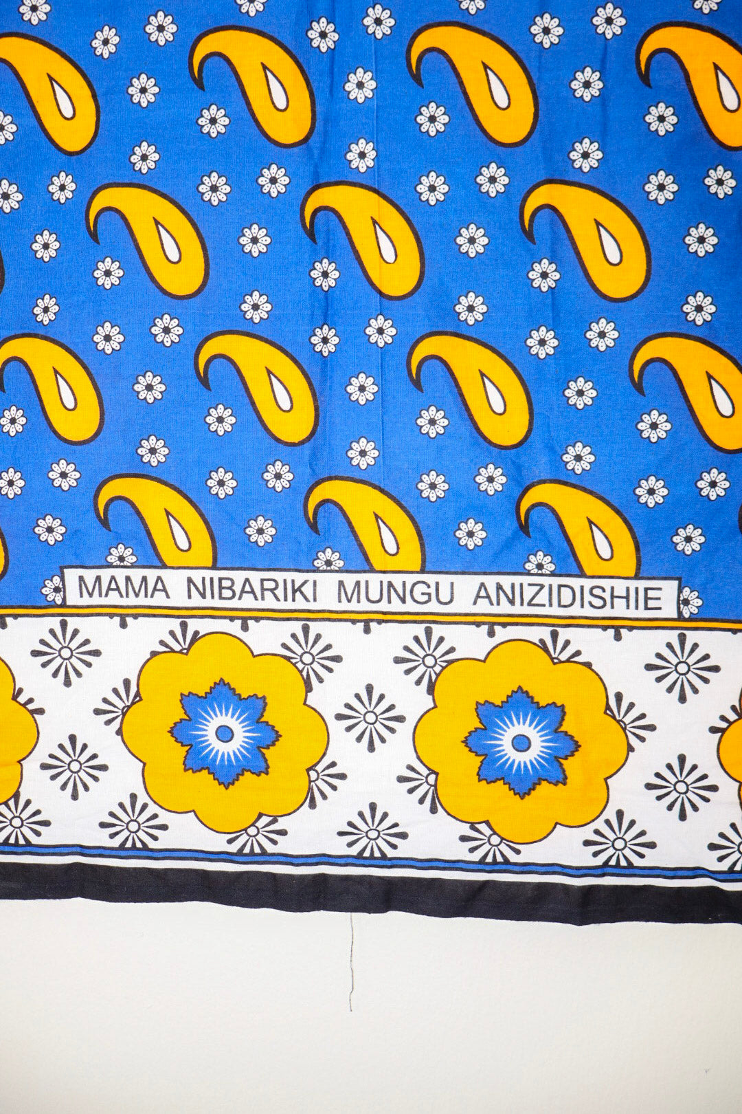Traditional fabric with yellow patterns on a blue and white background