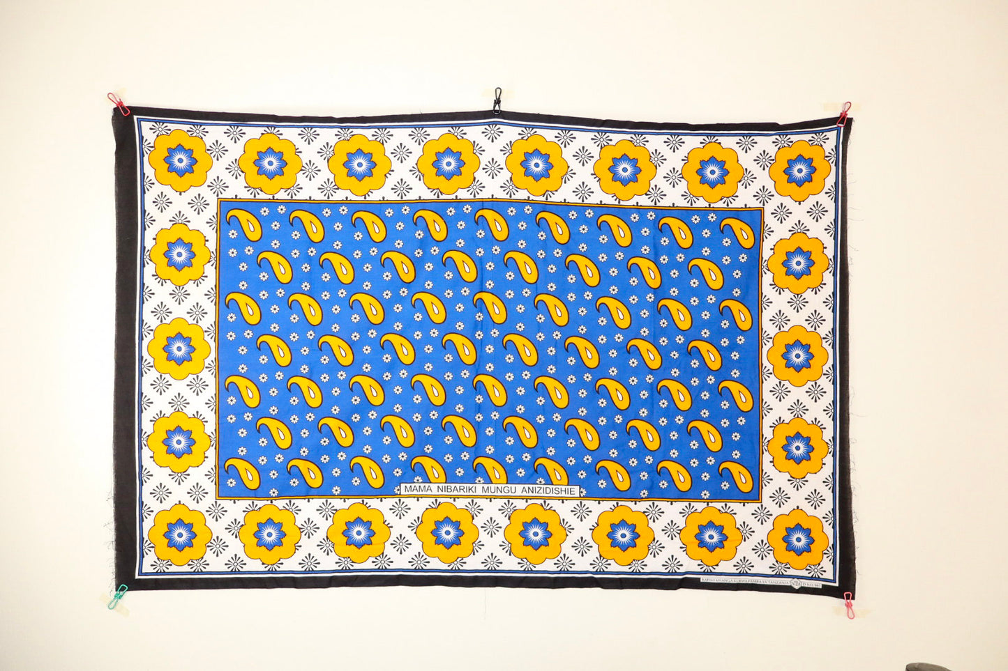 Decorative wall hanging with blue background and yellow patterns
