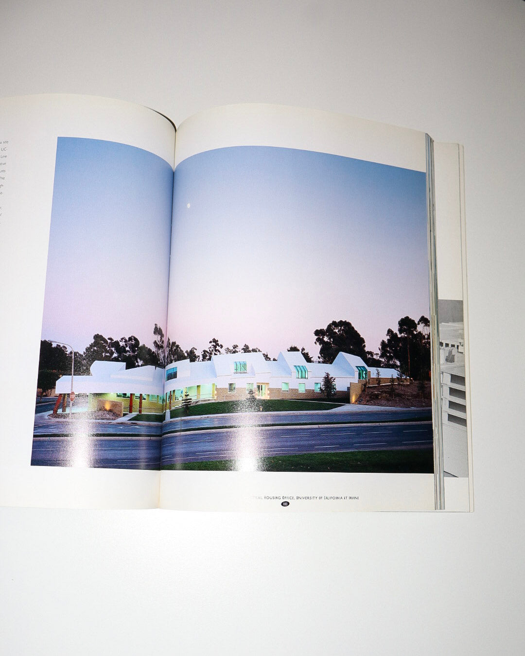 Open book showing a photograph of a building with a blue sky.