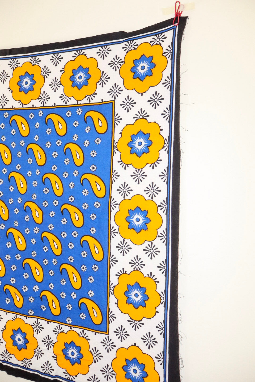 Decorative fabric with blue and yellow patterns on a white background