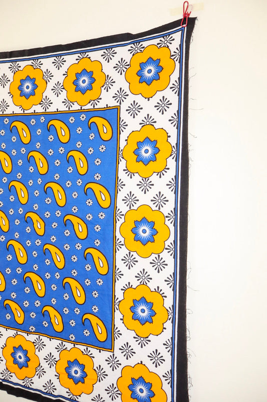 Decorative fabric with blue and yellow patterns on a white background