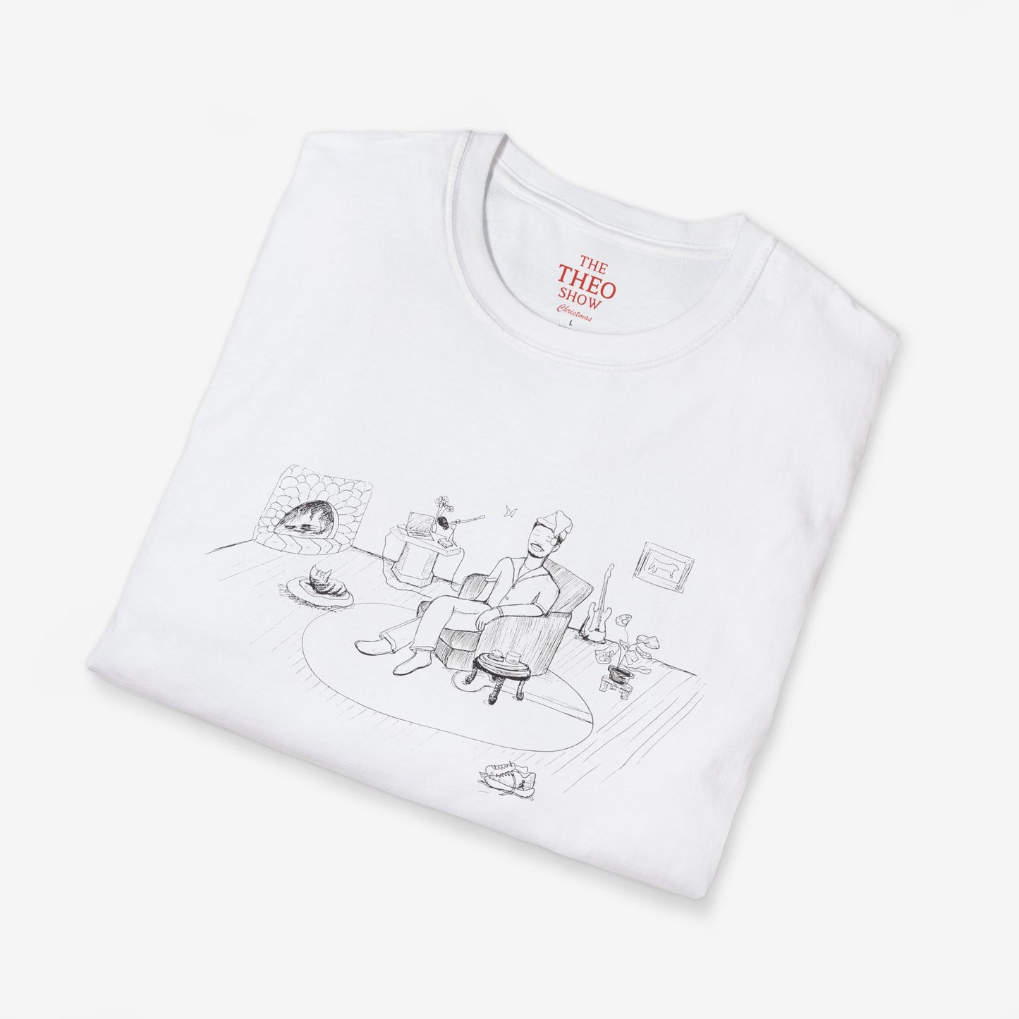 Folded white t-shirt with black graphic design and 'THEO SHOW' branding on a light gray background