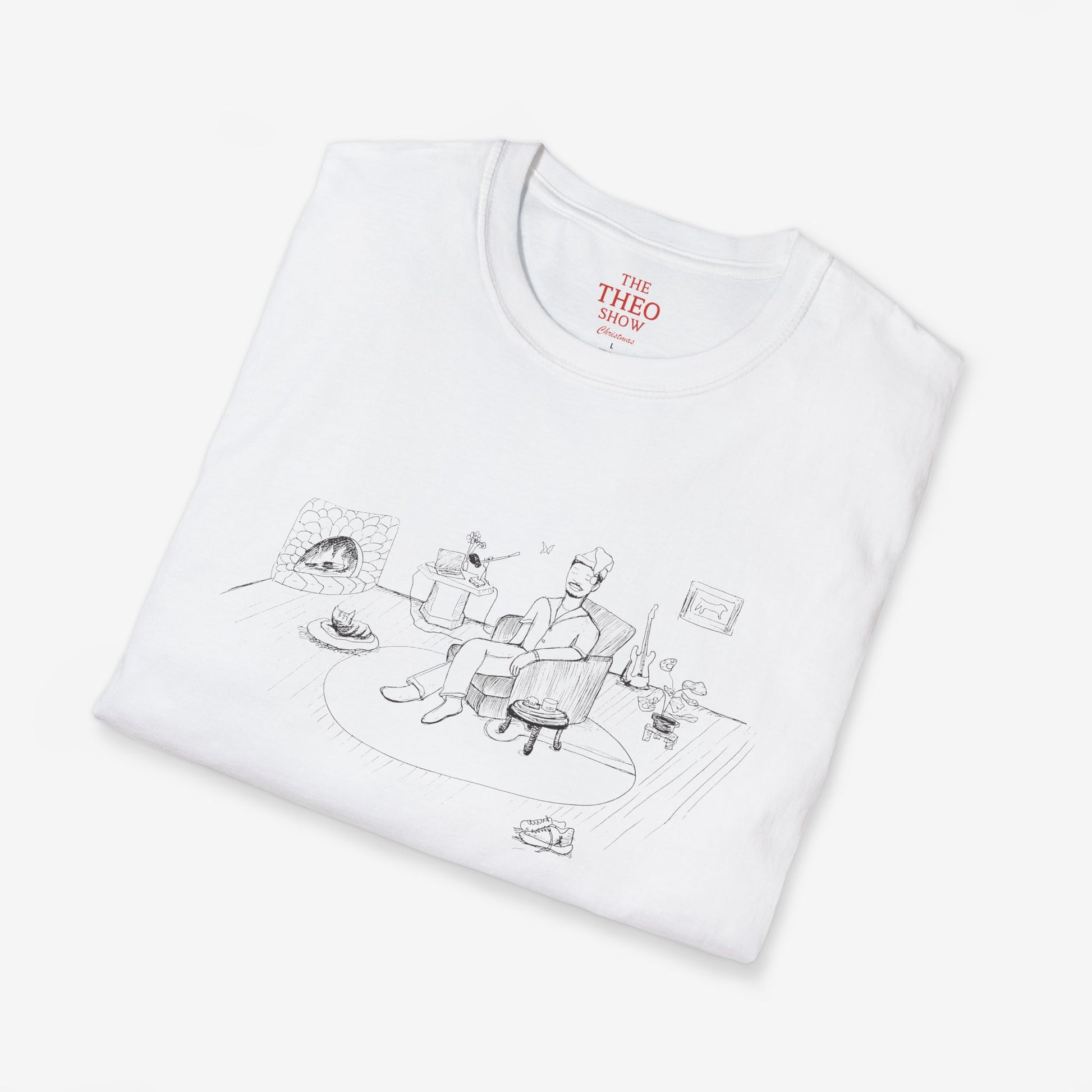 Folded white t-shirt with black graphic design and 'THEO SHOW' branding on a light gray background