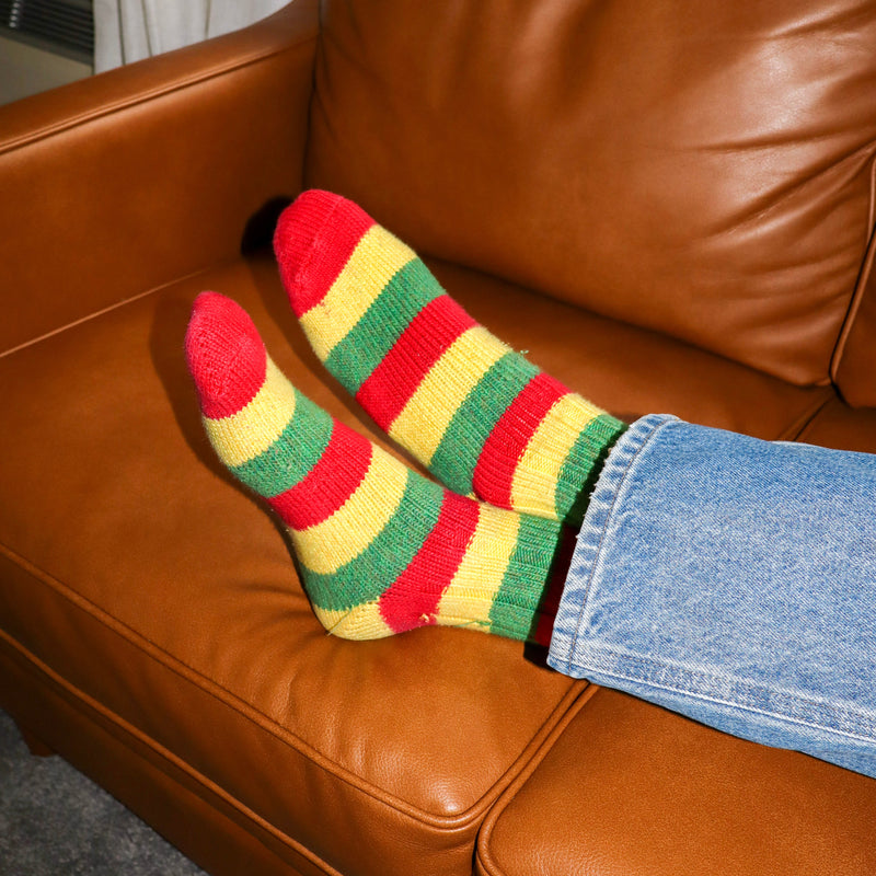 Colorful striped socks on a brown leather couch