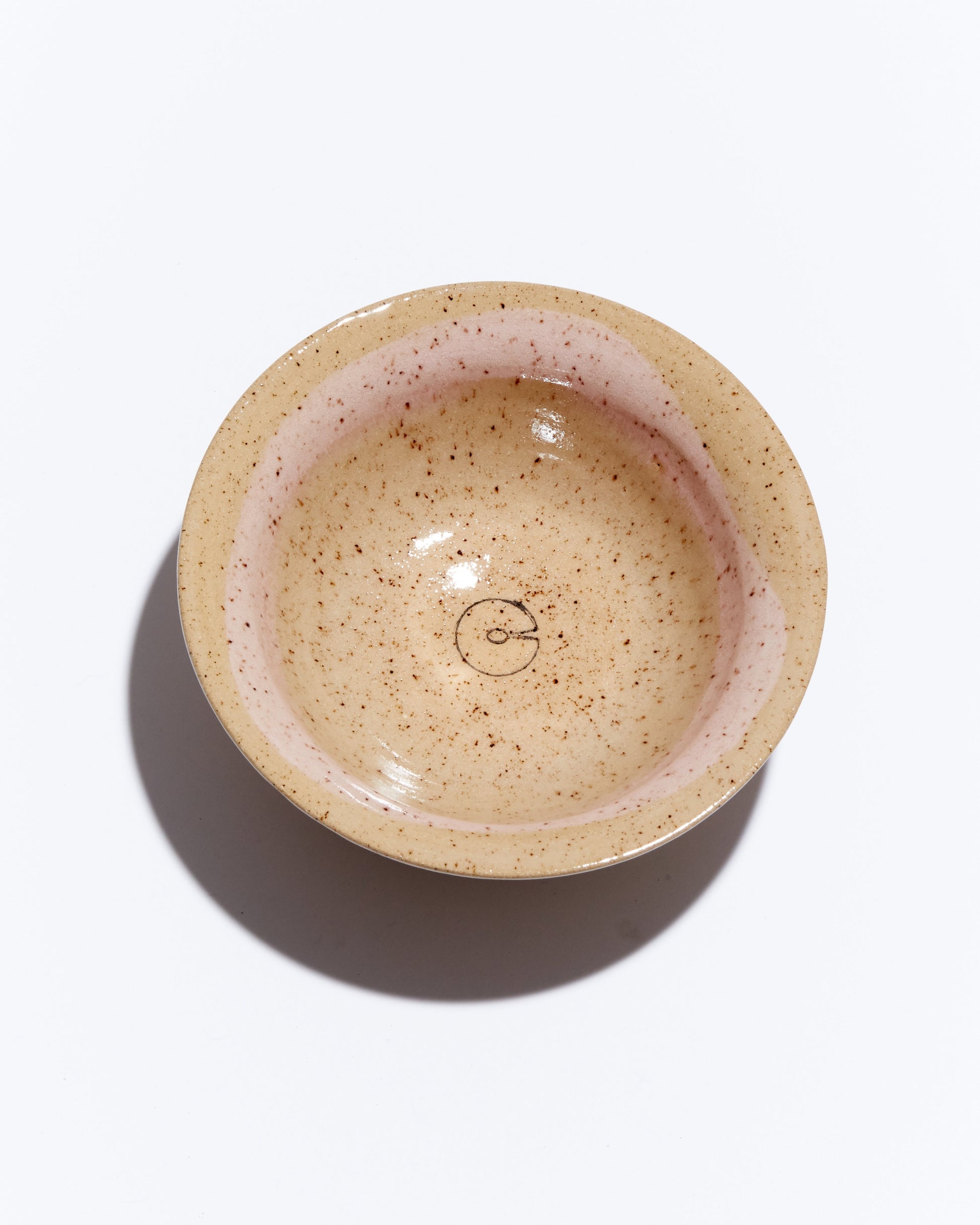 Speckled ceramic bowl on a white background