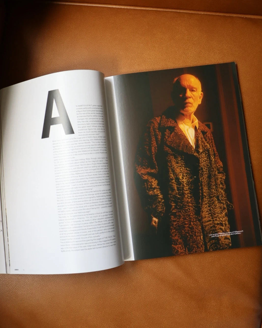 Open book with a photograph of a person on a brown surface